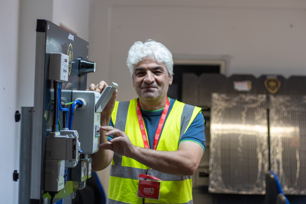 A learner working on a consumer-unit training board