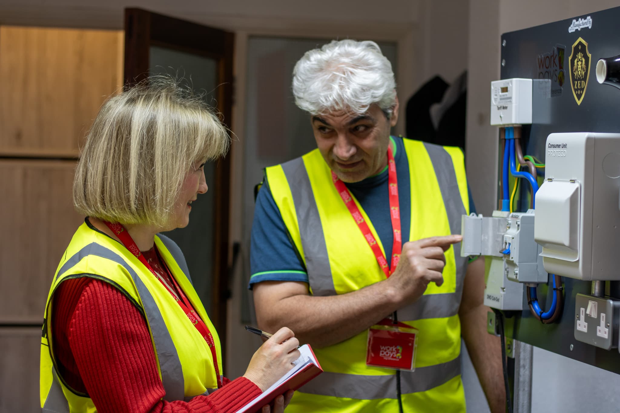 Trainer and learner reviewing a consumer unit together